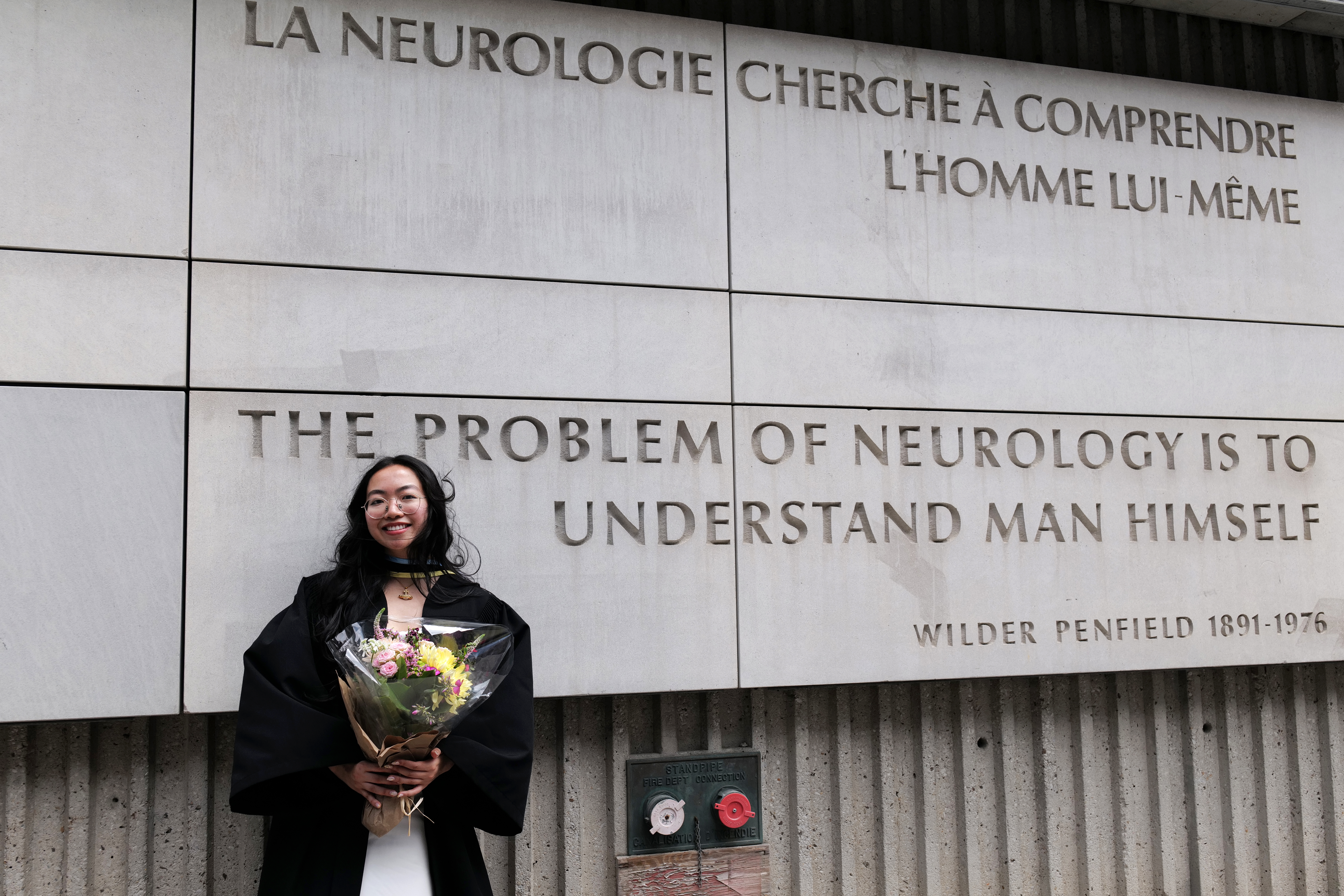 Le Thuy Duong Nguyen standing in front of Wilder Penfield quote at The Neuro, 2025